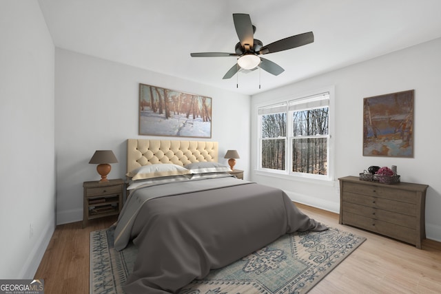 bedroom with wood finished floors, baseboards, and ceiling fan