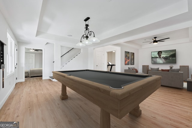 game room featuring ceiling fan, pool table, light wood-style floors, and a raised ceiling