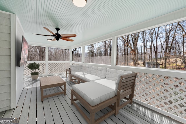 sunroom / solarium with a ceiling fan