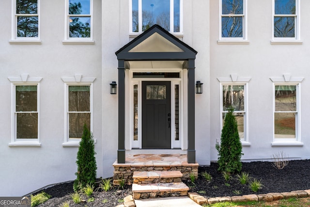 view of exterior entry with stucco siding