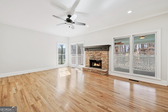 unfurnished living room with ceiling fan, crown molding, wood finished floors, and visible vents