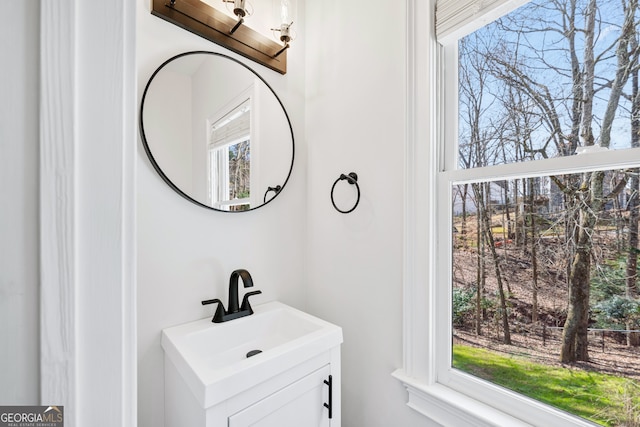 bathroom with plenty of natural light and vanity