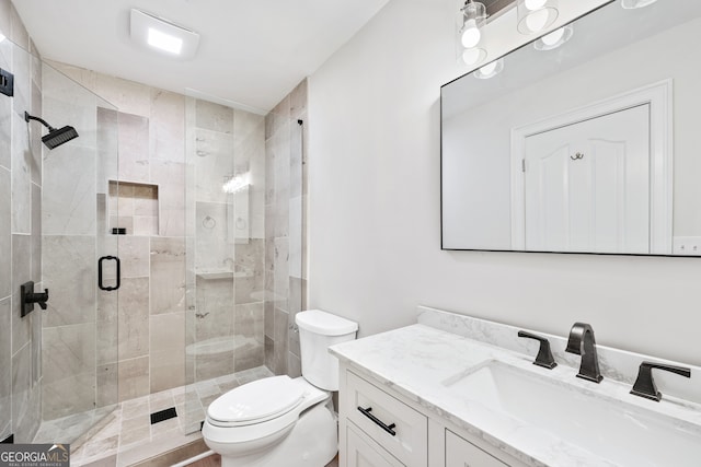 full bath featuring toilet, vanity, and a stall shower