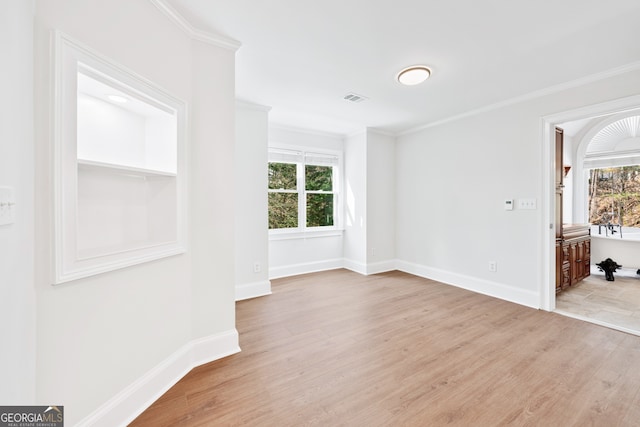 spare room with baseboards, wood finished floors, and a healthy amount of sunlight