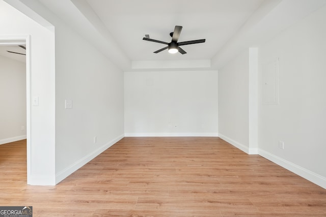 spare room with light wood-type flooring, baseboards, and ceiling fan