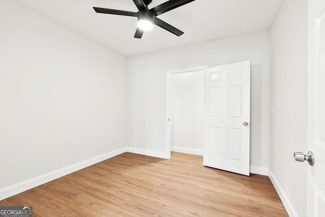 unfurnished bedroom with baseboards, a ceiling fan, and light wood finished floors