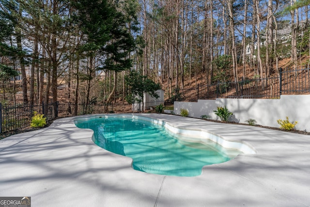 view of swimming pool featuring fence, a fenced in pool, and a patio