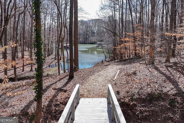dock area featuring a view of trees and a water view