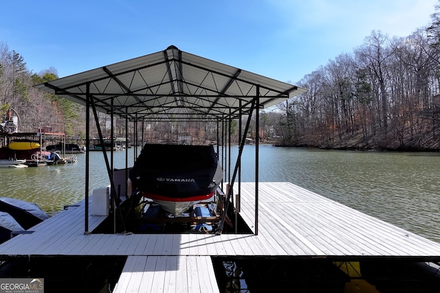 dock area with boat lift and a water view