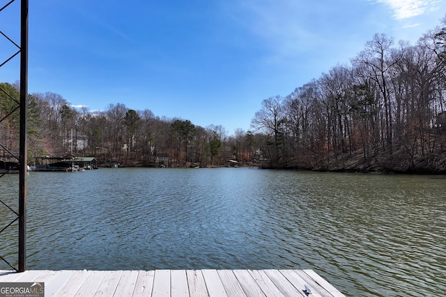 dock area with a view of trees and a water view