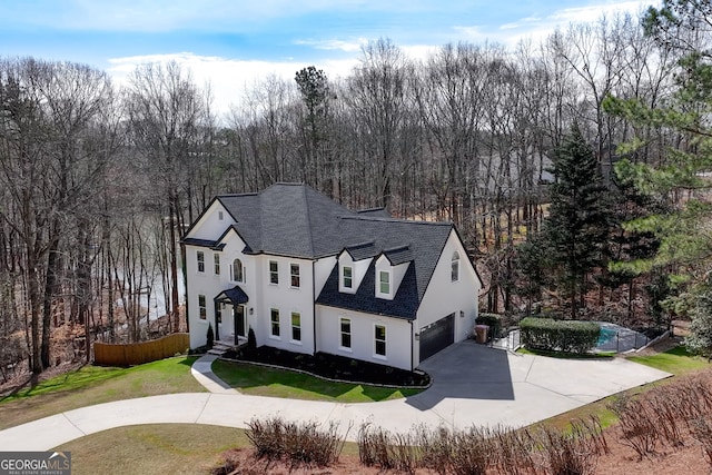exterior space featuring an outdoor pool, a front lawn, driveway, roof with shingles, and a garage