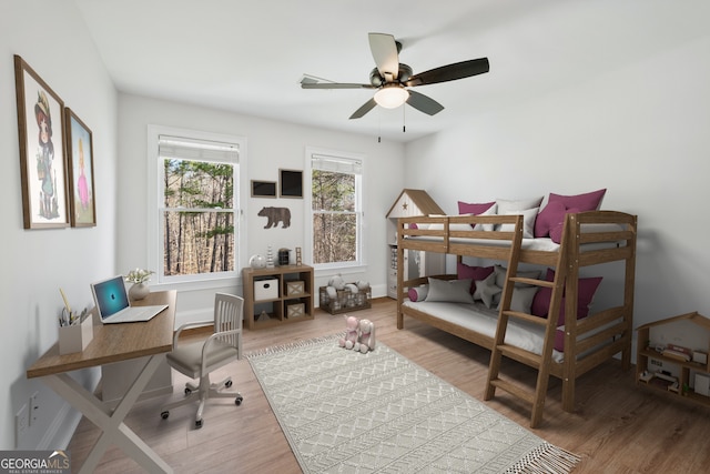 bedroom featuring wood finished floors and baseboards