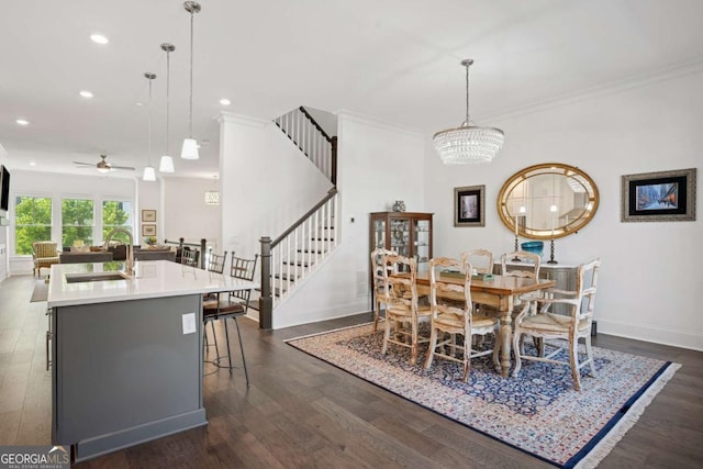 2004 Cortland Rd, Milton, GA 30009 - kitchen featuring wall chimney exhaust hood, open floor plan, a ceiling fan, a breakfast bar, and dark wood-type flooring