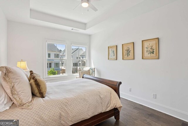 2004 Cortland Rd, Milton, GA 30009 - bedroom featuring a tray ceiling, visible vents, baseboards, a ceiling fan, and dark wood-type flooring
