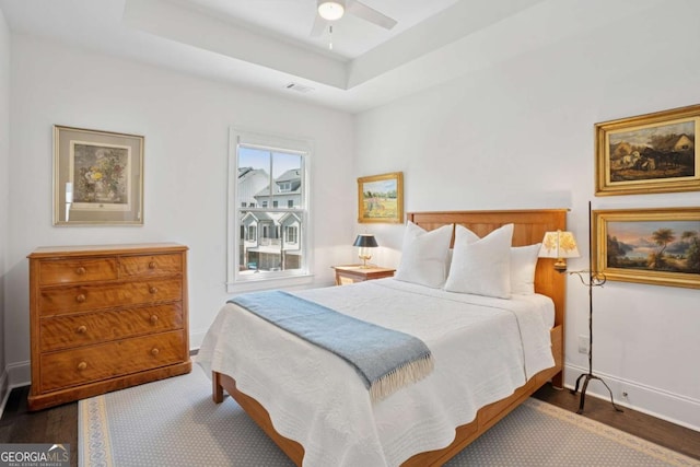 2004 Cortland Rd, Milton, GA 30009 - bedroom featuring a tray ceiling, visible vents, a ceiling fan, dark wood-type flooring, and baseboards