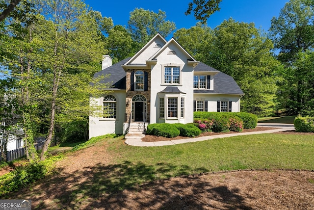 1820 Lyon Ave SW, Atlanta, GA 30331 - view of front of home with stucco siding, a front lawn, a chimney, and stone siding
