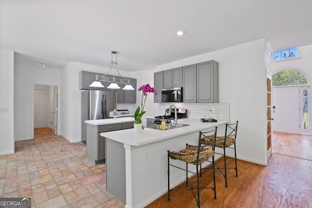 1820 Lyon Ave SW, Atlanta, GA 30331 - kitchen featuring gray cabinets, stainless steel appliances, light countertops, and a peninsula