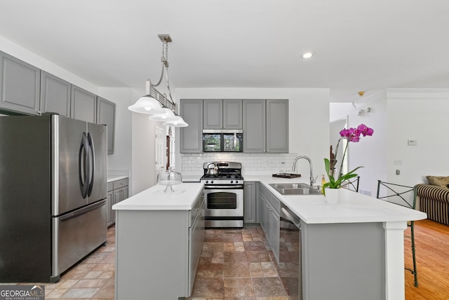 1820 Lyon Ave SW, Atlanta, GA 30331 - kitchen featuring stainless steel appliances, gray cabinetry, a peninsula, a kitchen island, and tasteful backsplash