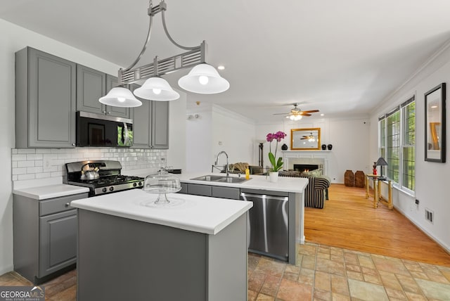 1820 Lyon Ave SW, Atlanta, GA 30331 - kitchen with stainless steel appliances, gray cabinetry, light countertops, a peninsula, and a kitchen island