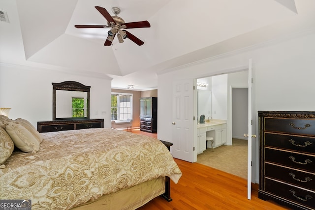 1820 Lyon Ave SW, Atlanta, GA 30331 - bedroom featuring light wood-type flooring, a raised ceiling, crown molding, vaulted ceiling, and ensuite bathroom