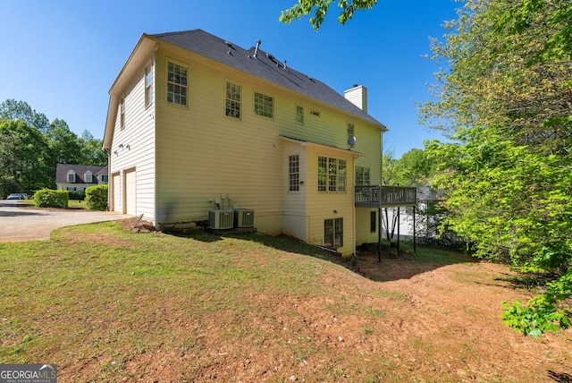 1820 Lyon Ave SW, Atlanta, GA 30331 - back of property featuring an attached garage, concrete driveway, a chimney, a yard, and a wooden deck