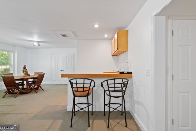 1820 Lyon Ave SW, Atlanta, GA 30331 - kitchen with a kitchen breakfast bar, light carpet, a peninsula, and recessed lighting