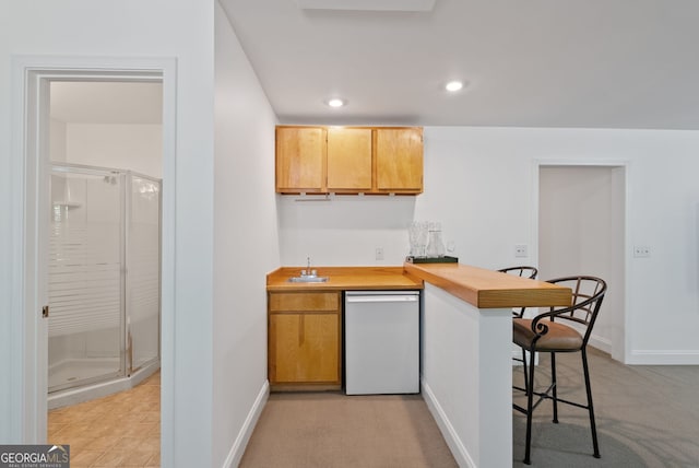 1820 Lyon Ave SW, Atlanta, GA 30331 - kitchen with dishwasher, a breakfast bar, a peninsula, light countertops, and recessed lighting