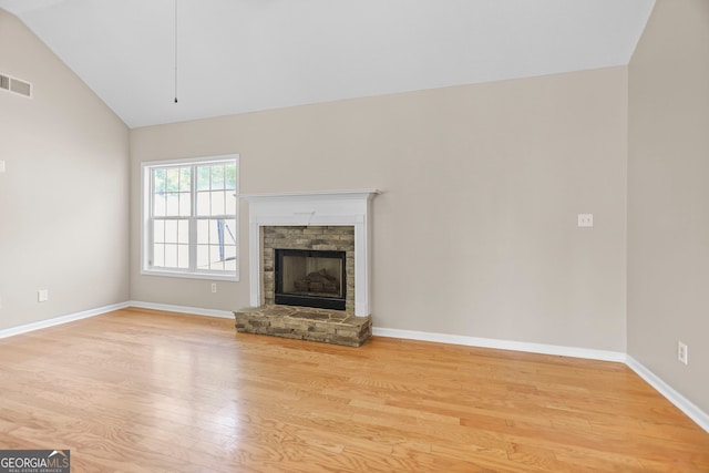 120 Hidden Brook Trl, Newnan, GA 30265 - unfurnished living room with lofted ceiling, light wood-style flooring, and a fireplace