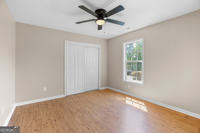 120 Hidden Brook Trl, Newnan, GA 30265 - unfurnished bedroom featuring wood finished floors, a closet, and a ceiling fan