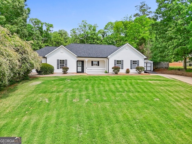 120 Hidden Brook Trl, Newnan, GA 30265 - ranch-style home featuring a storage shed, a front yard, a shingled roof, and view of scattered trees