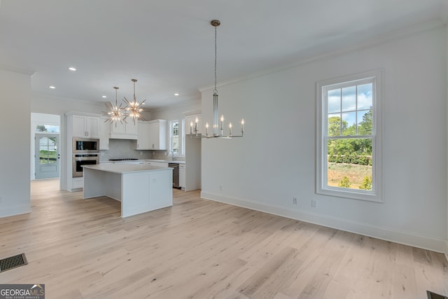 kitchen featuring visible vents, an inviting chandelier, appliances with stainless steel finishes, and crown molding