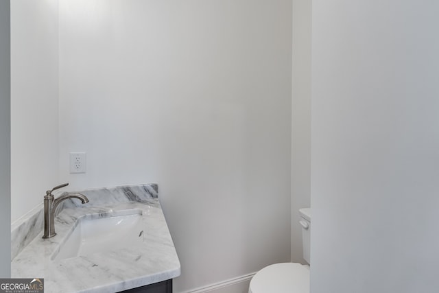 bathroom featuring toilet and vanity
