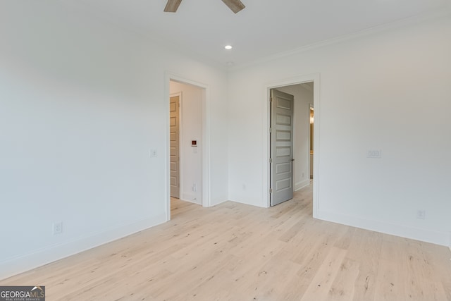 empty room with light wood-style flooring, ornamental molding, baseboards, and ceiling fan