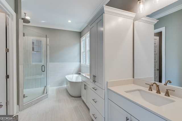 bathroom featuring recessed lighting, a shower stall, vanity, crown molding, and a soaking tub