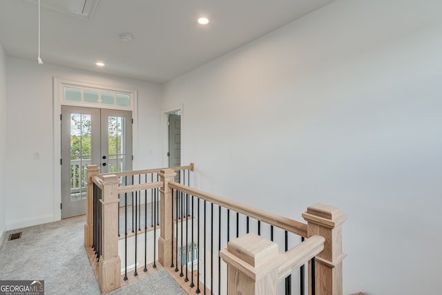 hallway featuring attic access, french doors, visible vents, recessed lighting, and an upstairs landing