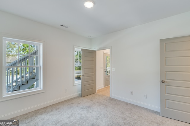 unfurnished bedroom featuring visible vents, baseboards, and carpet floors