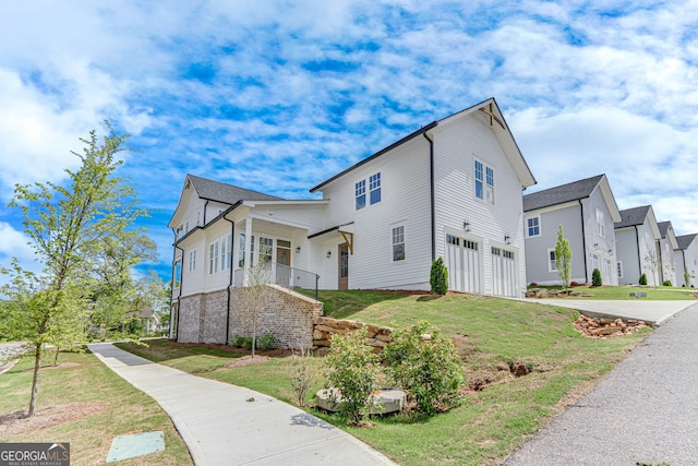 view of property exterior with a residential view, an attached garage, concrete driveway, and a lawn
