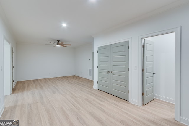 unfurnished living room featuring light wood-type flooring, baseboards, visible vents, a ceiling fan, and crown molding