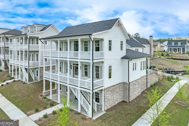 exterior space with a residential view, a balcony, and a shingled roof
