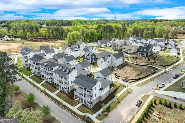 drone / aerial view with a view of trees and a residential view