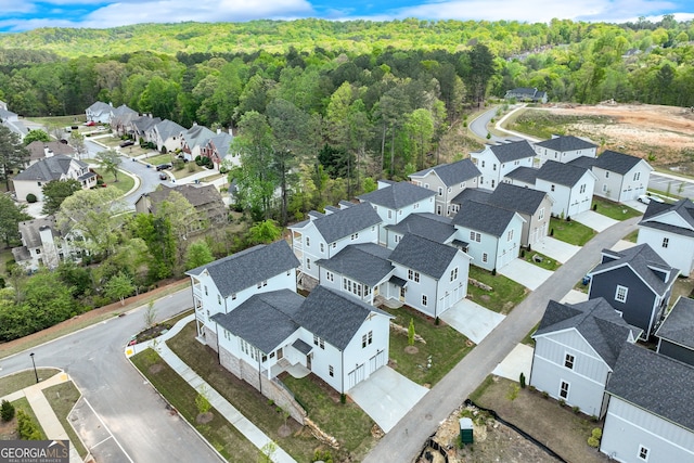 birds eye view of property with a forest view and a residential view