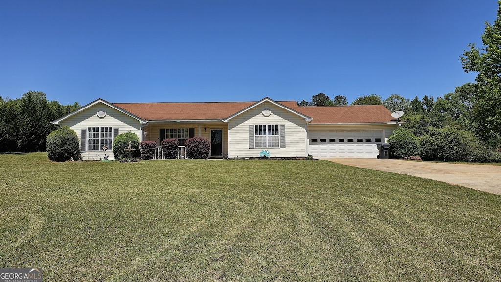 391 Maple Ridge Dr, Jackson, GA 30233 - ranch-style house featuring an attached garage, a porch, a front lawn, and concrete driveway