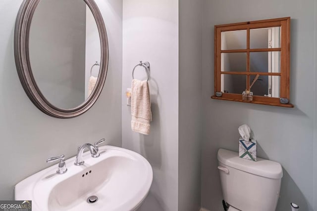 half bathroom with a sink and toilet