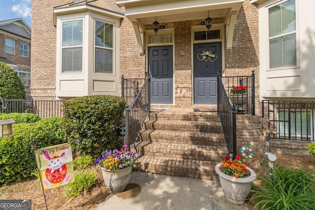 view of exterior entry featuring brick siding
