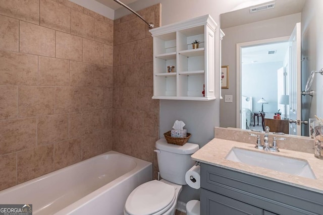 full bath with toilet, vanity, and shower / washtub combination
