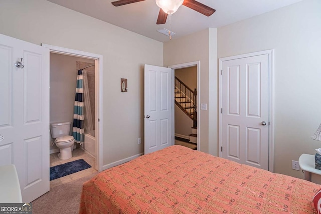 bedroom featuring carpet floors, connected bathroom, and ceiling fan