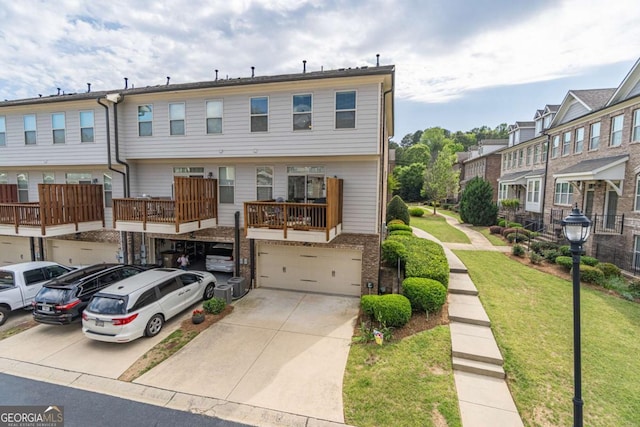 view of front facade featuring an attached garage, driveway, brick siding, and a front lawn