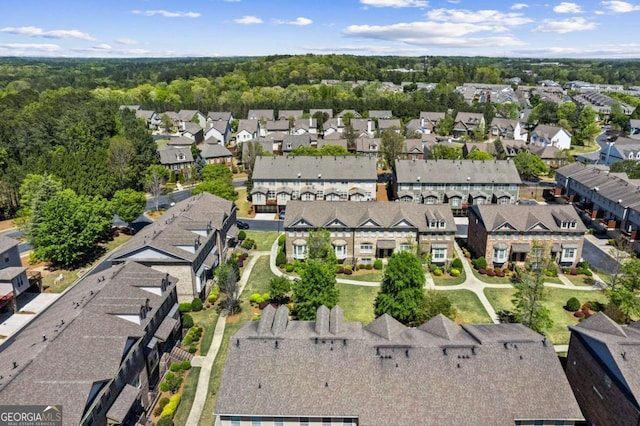 aerial view of property and surrounding area featuring nearby suburban area