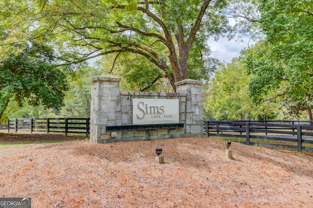 community / neighborhood sign with fence