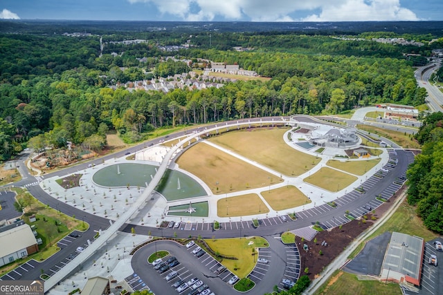 aerial view of property and surrounding area with a forest